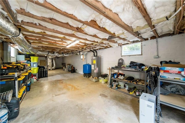 below grade area featuring water heater and a water pressure tank