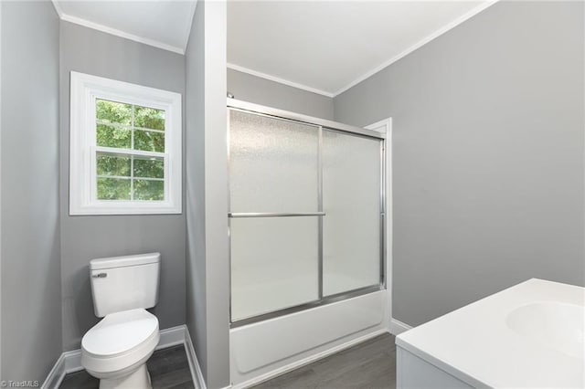 full bathroom featuring bath / shower combo with glass door, hardwood / wood-style flooring, vanity, and toilet