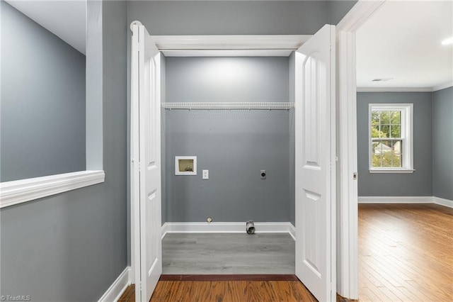 laundry area featuring hookup for a washing machine, hardwood / wood-style flooring, ornamental molding, and electric dryer hookup