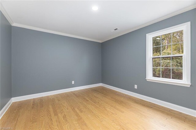 unfurnished room featuring light wood-type flooring and ornamental molding