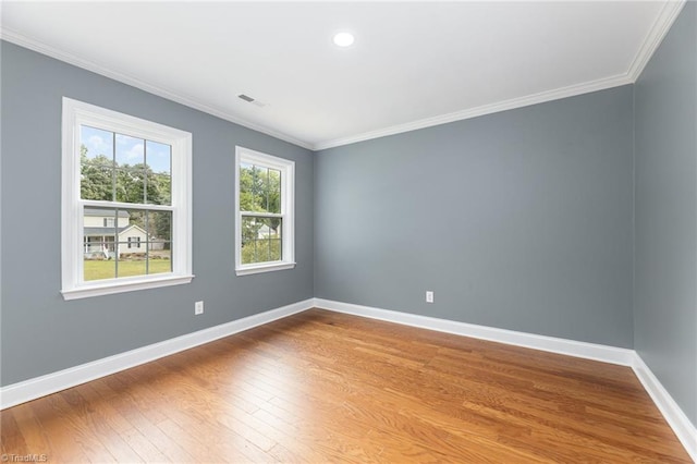 empty room featuring crown molding and hardwood / wood-style floors