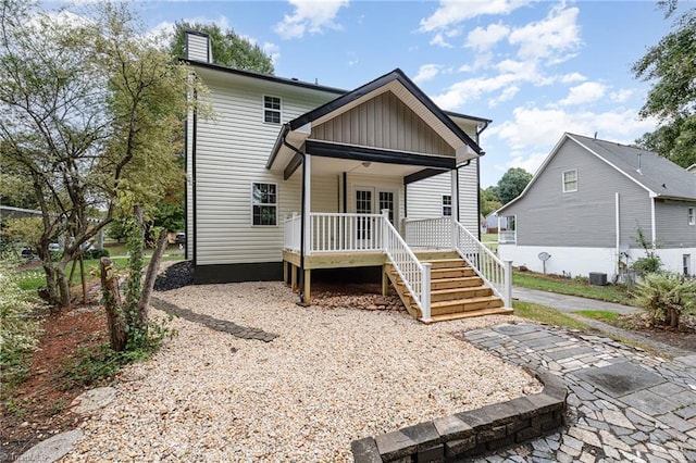 back of house featuring cooling unit and a porch