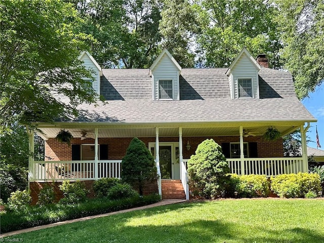 3501 River Ridge Rd, Pfafftown, NC 27040 - view of front facade with ceiling fan, a porch, a front yard, and brick siding