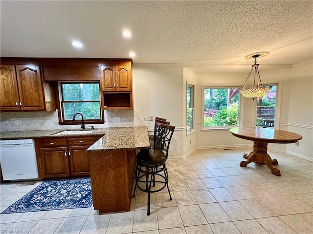 3501 River Ridge Rd, Pfafftown, NC 27040 - kitchen featuring a textured ceiling, white dishwasher, a sink, decorative backsplash, and healthy amount of natural light