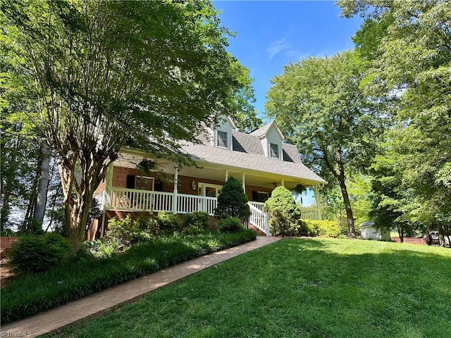 3501 River Ridge Rd, Pfafftown, NC 27040 - new england style home with a porch, a front yard, and brick siding