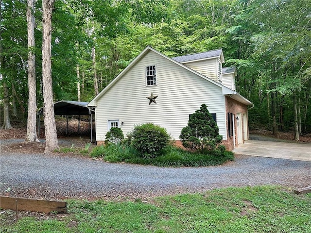 3501 River Ridge Rd, Pfafftown, NC 27040 - view of property exterior with gravel driveway, a forest view, and a carport