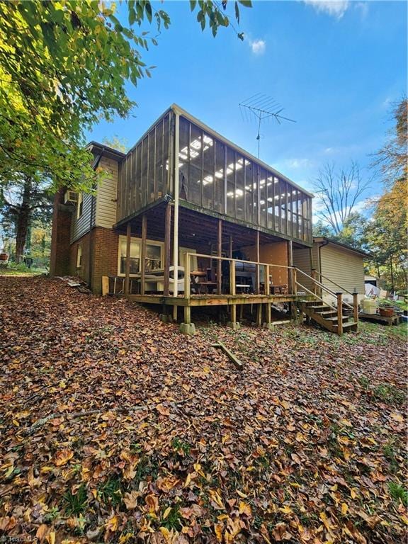 back of house featuring a sunroom