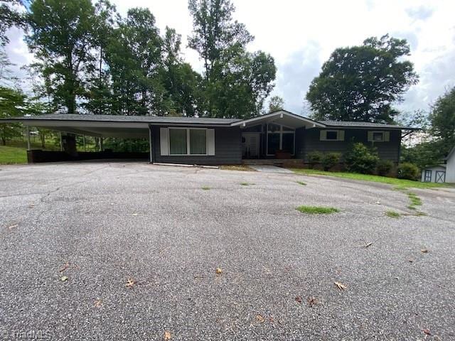 single story home featuring a carport