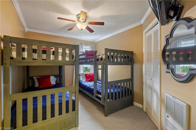 bedroom with ceiling fan, crown molding, a textured ceiling, and carpet flooring