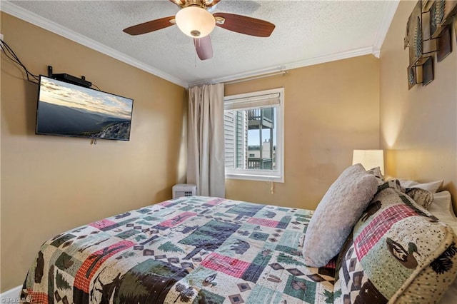 bedroom featuring ceiling fan, a textured ceiling, and crown molding