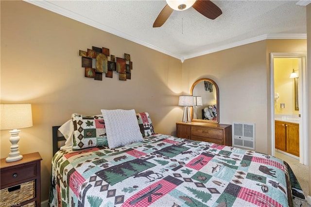 bedroom featuring ceiling fan, ensuite bathroom, crown molding, heating unit, and a textured ceiling