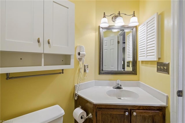 bathroom featuring toilet and vanity