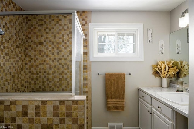 bathroom featuring vanity and an enclosed shower