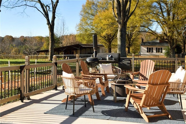 wooden terrace with a fire pit