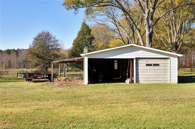 view of outdoor structure with a garage and a yard