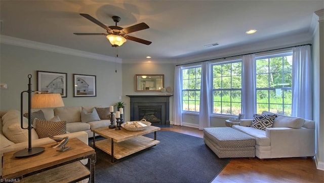 living room with dark hardwood / wood-style floors, ornamental molding, and ceiling fan