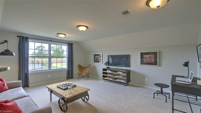 carpeted living room featuring lofted ceiling