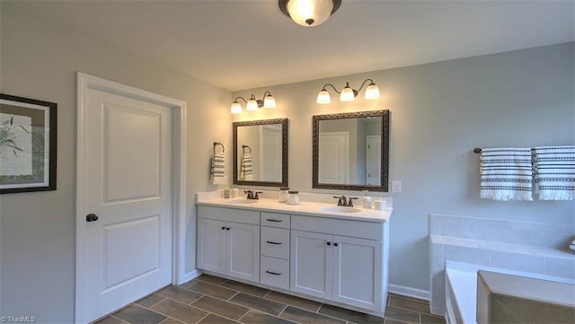 bathroom featuring a tub to relax in and vanity