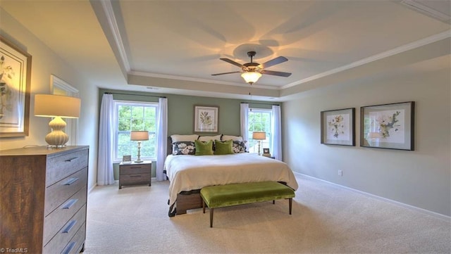 bedroom featuring multiple windows, ceiling fan, a raised ceiling, and light colored carpet