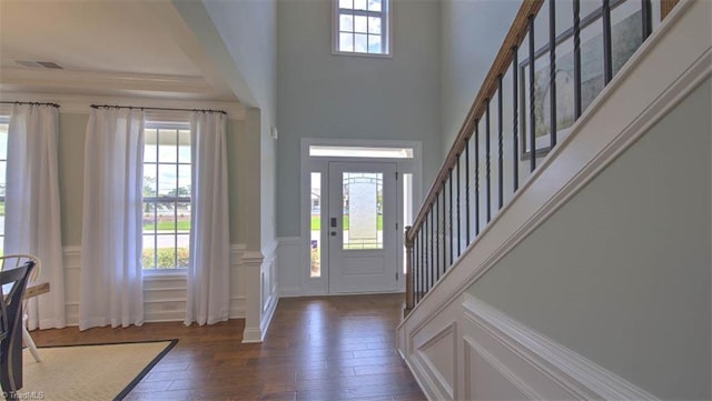 entryway featuring a high ceiling and dark hardwood / wood-style flooring