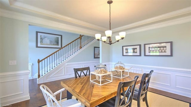 dining room with ornamental molding, dark hardwood / wood-style floors, and an inviting chandelier