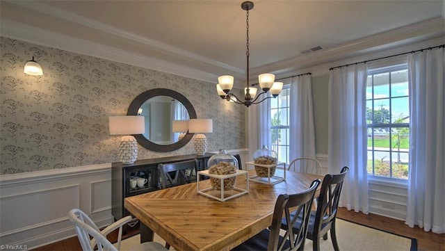 dining room featuring crown molding, an inviting chandelier, and wood-type flooring