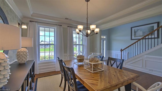 dining area with crown molding, a wealth of natural light, dark wood-type flooring, and an inviting chandelier