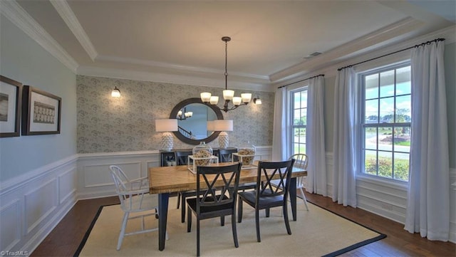 dining room featuring dark wood-type flooring, plenty of natural light, and a chandelier