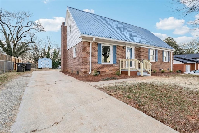 bungalow-style home featuring a storage shed