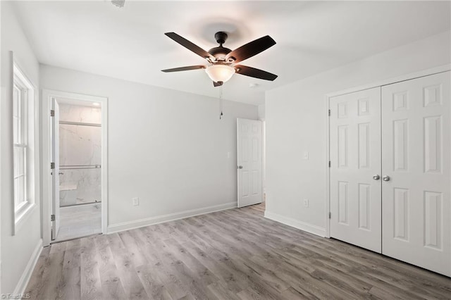 202 Aldridge Ln, Archdale, NC 27263 - unfurnished bedroom with wood finished floors, a closet, baseboards, and connected bathroom