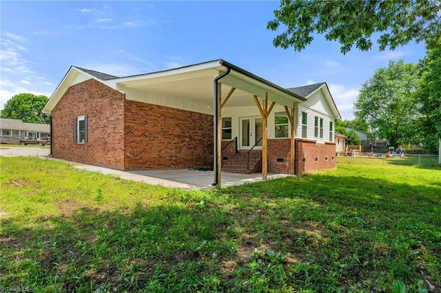 202 Aldridge Ln, Archdale, NC 27263 - view of property exterior with brick siding and a patio area