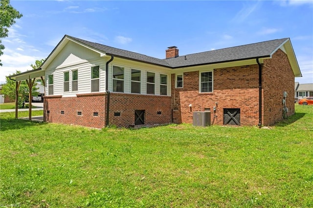 202 Aldridge Ln, Archdale, NC 27263 - rear view of property featuring brick siding, central AC unit, a lawn, and a chimney