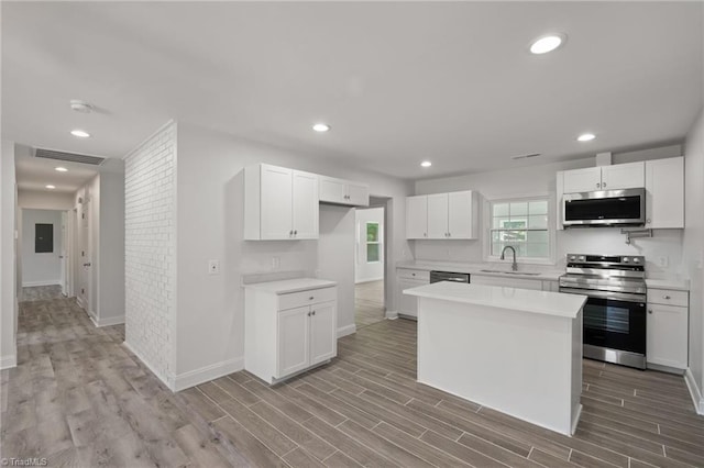 202 Aldridge Ln, Archdale, NC 27263 - kitchen with appliances with stainless steel finishes, a sink, light wood-type flooring, light countertops, and recessed lighting
