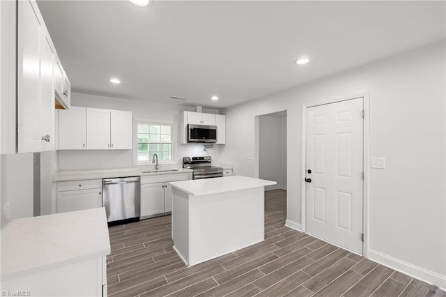 202 Aldridge Ln, Archdale, NC 27263 - kitchen with appliances with stainless steel finishes, a sink, dark wood-style floors, light countertops, and recessed lighting