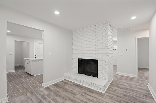 202 Aldridge Ln, Archdale, NC 27263 - unfurnished living room featuring light wood finished floors, baseboards, a brick fireplace, and recessed lighting