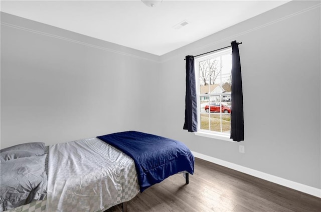 3304 Spring St, Greensboro, NC 27405 - bedroom with baseboards, visible vents, and wood finished floors