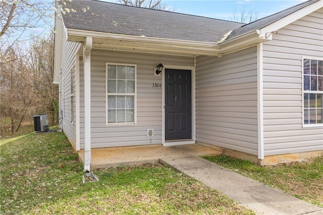 3304 Spring St, Greensboro, NC 27405 - entrance to property with a shingled roof, central AC unit, and a yard
