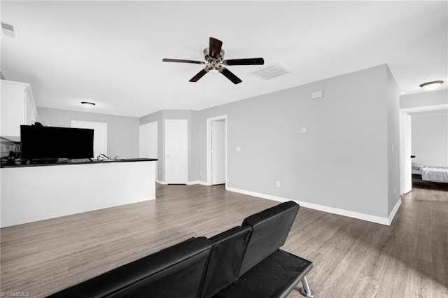 3304 Spring St, Greensboro, NC 27405 - unfurnished living room with baseboards, visible vents, wood finished floors, and a ceiling fan