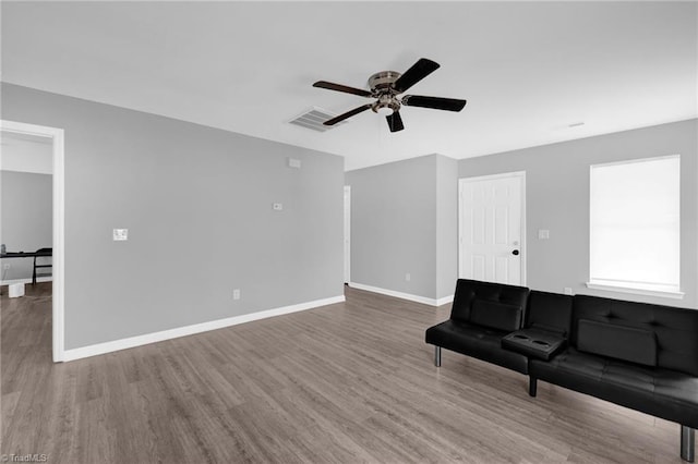 3304 Spring St, Greensboro, NC 27405 - unfurnished living room with ceiling fan, baseboards, visible vents, and wood finished floors