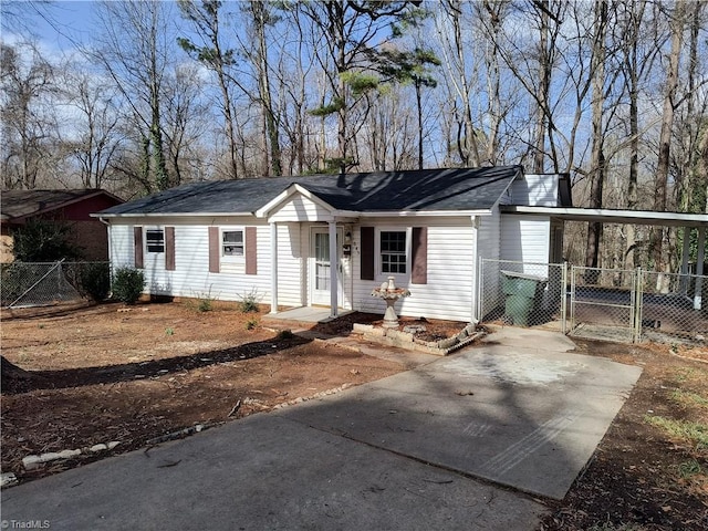 view of front of home with an attached carport, a gate, driveway, and fence