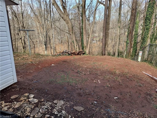 view of yard with a view of trees