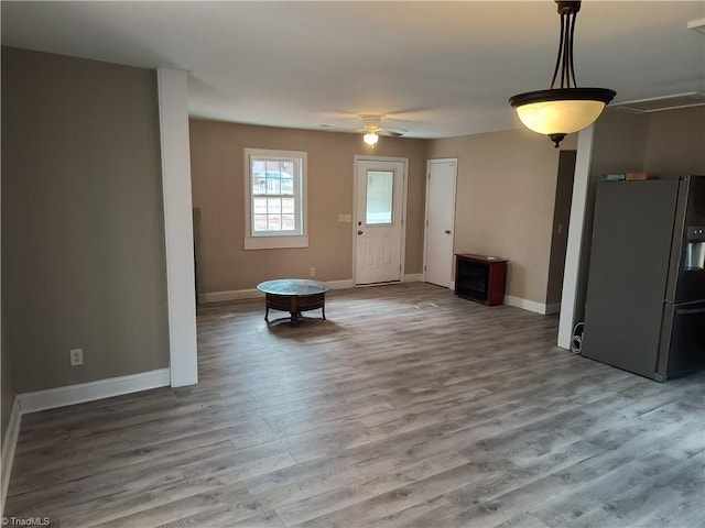 foyer featuring ceiling fan, baseboards, and wood finished floors