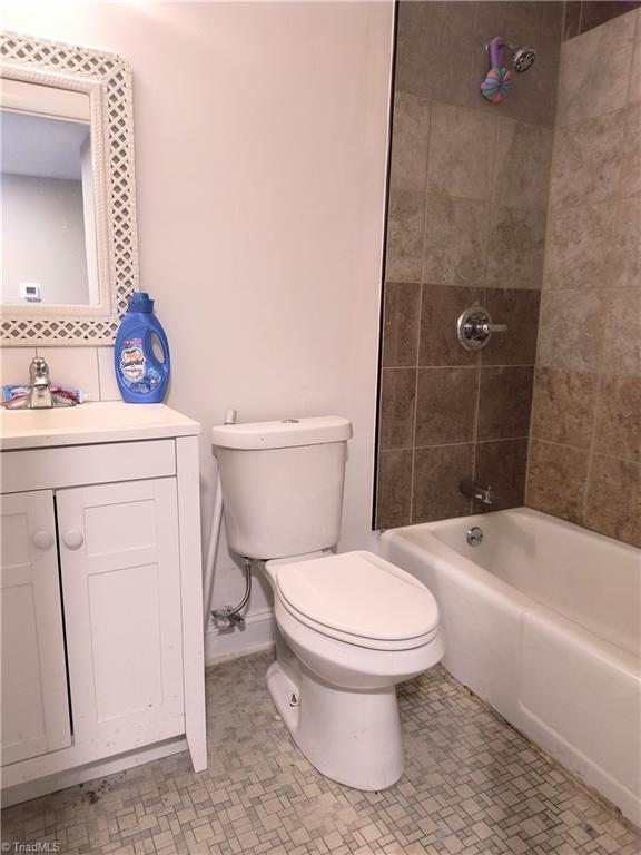 full bathroom featuring shower / bath combination, vanity, and toilet