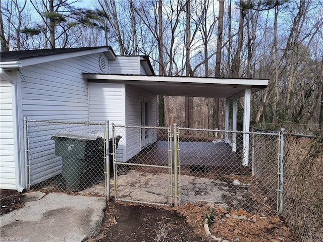 view of home's exterior with fence and a gate