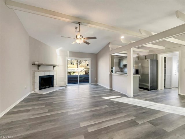 unfurnished living room featuring a fireplace, hardwood / wood-style floors, and lofted ceiling with beams