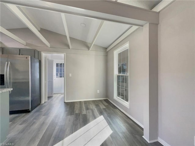 unfurnished dining area featuring vaulted ceiling with beams and dark hardwood / wood-style floors