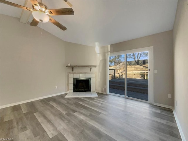 unfurnished living room with a fireplace, ceiling fan, lofted ceiling, and hardwood / wood-style floors