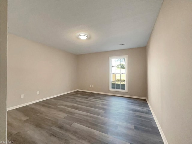 empty room featuring dark wood-type flooring