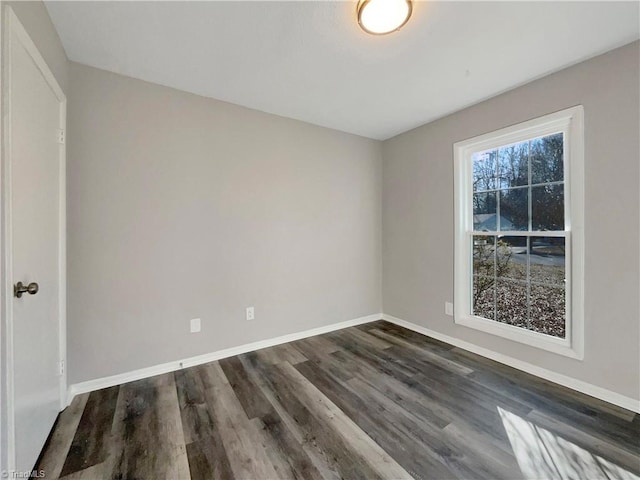 unfurnished room with dark hardwood / wood-style floors