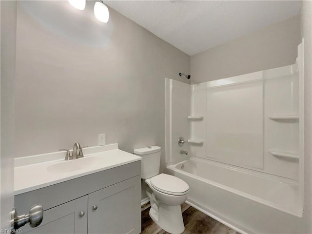 full bathroom featuring hardwood / wood-style flooring, toilet, vanity, and shower / bath combination